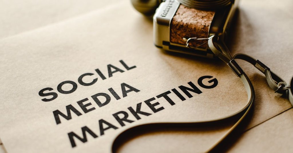 Close-up of a camera placed on brown paper with 'Social Media Marketing' text, emphasizing digital marketing themes.